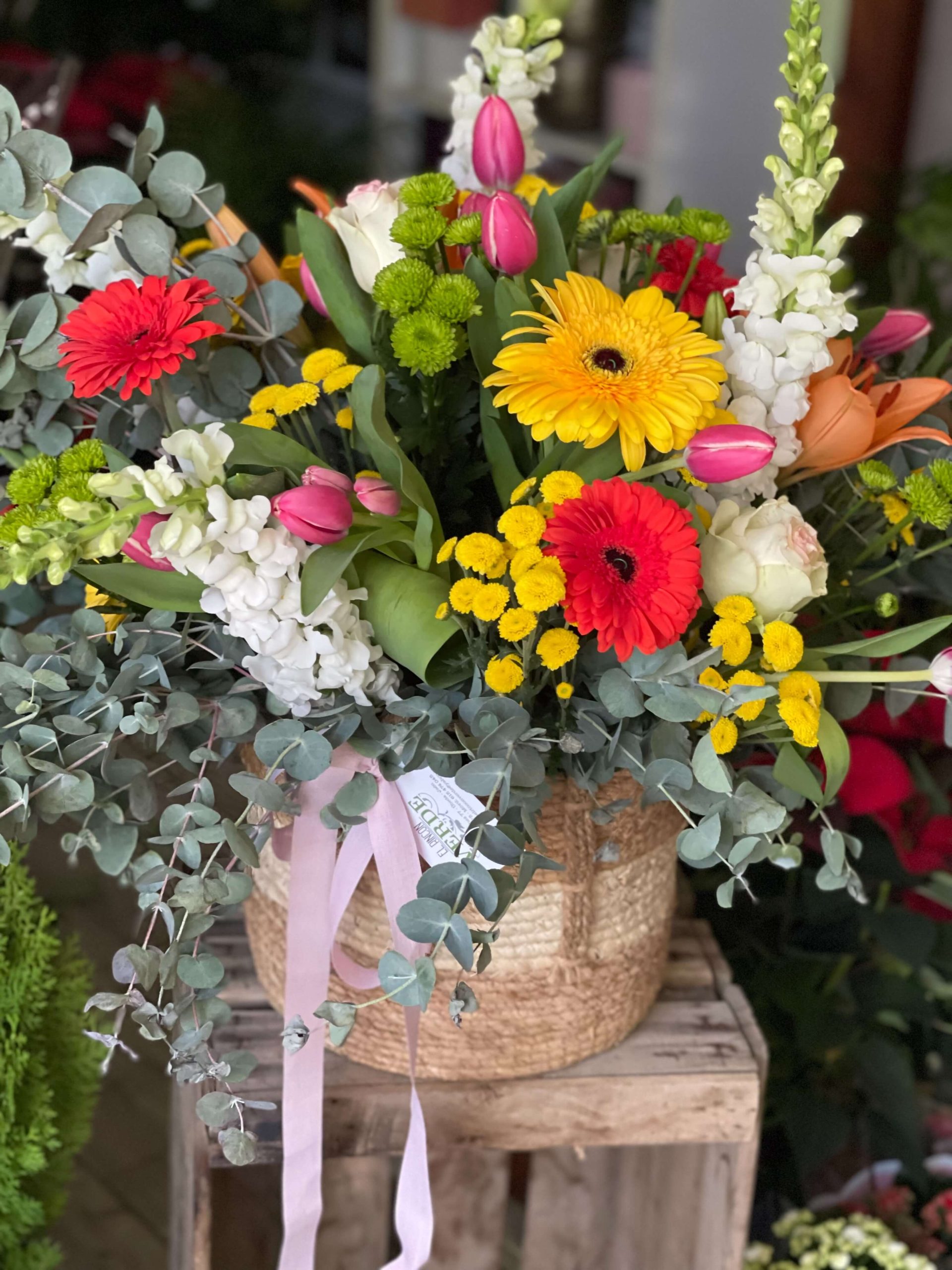 Ramo de flores con colores vivos en una cesta de mimbre